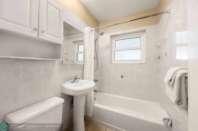 a bathroom with a sink a toilet and bathtub