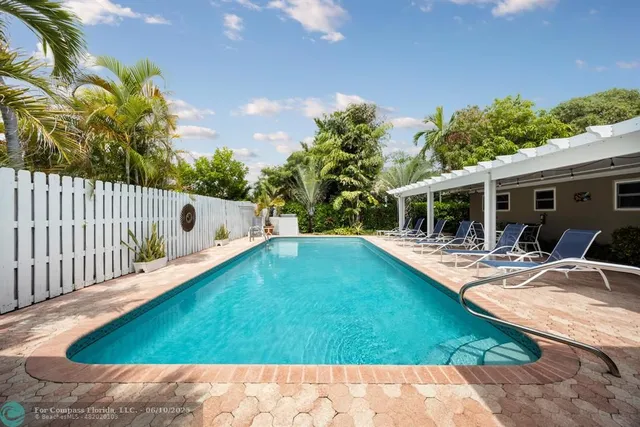 a view of backyard with swimming pool and porch