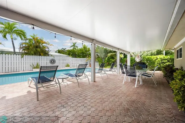 a view of a patio with a table and chairs
