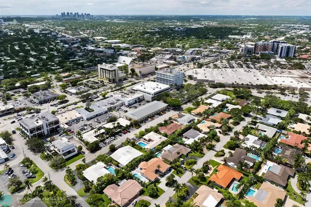an aerial view of residential houses with city view