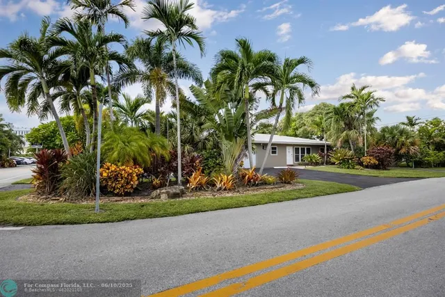 a front view of multi story residential apartment building with yard and green space
