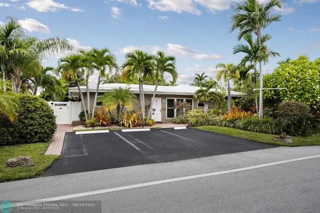 a view of a street with palm trees
