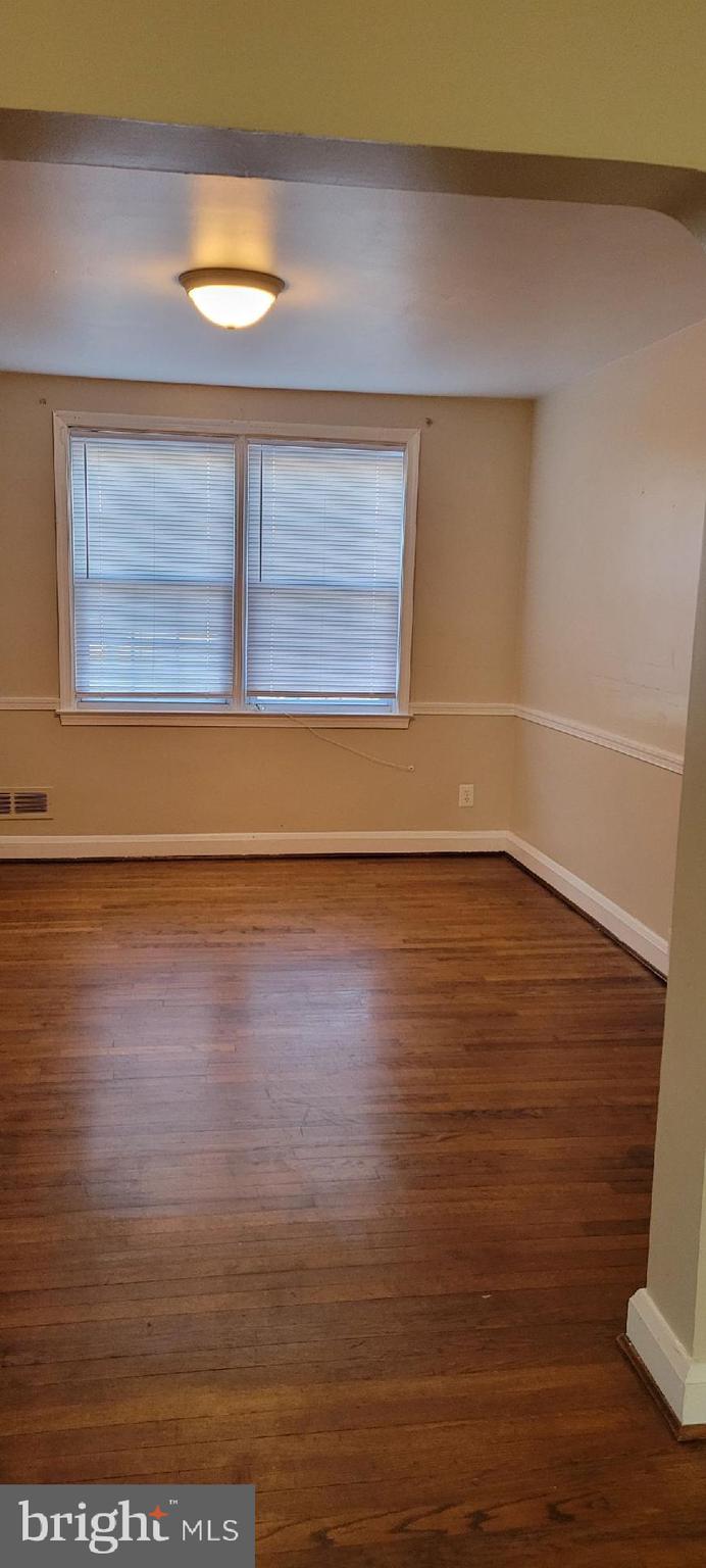 8203 Lasalle Road Towson, MD 21286 - Photo 3 of 17 a view of an empty room with wooden floor and a window