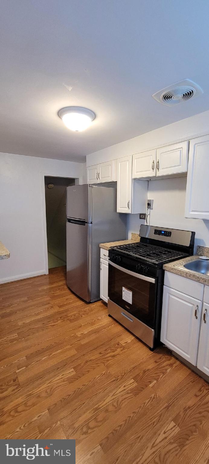 8203 Lasalle Road Towson, MD 21286 - Photo 4 of 17 a kitchen with stainless steel appliances granite countertop a stove a sink and a refrigerator