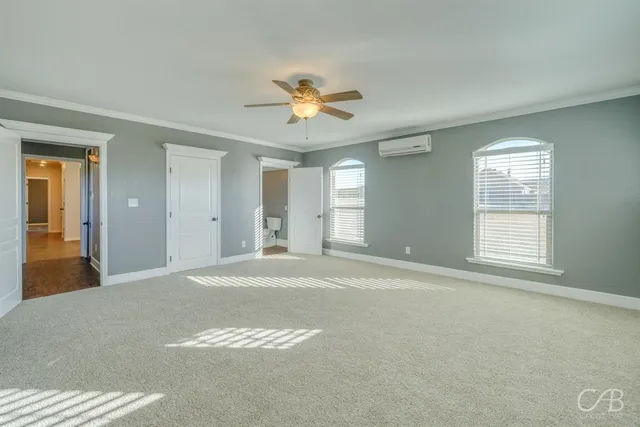 a view of a livingroom with a chandelier fan and a living room