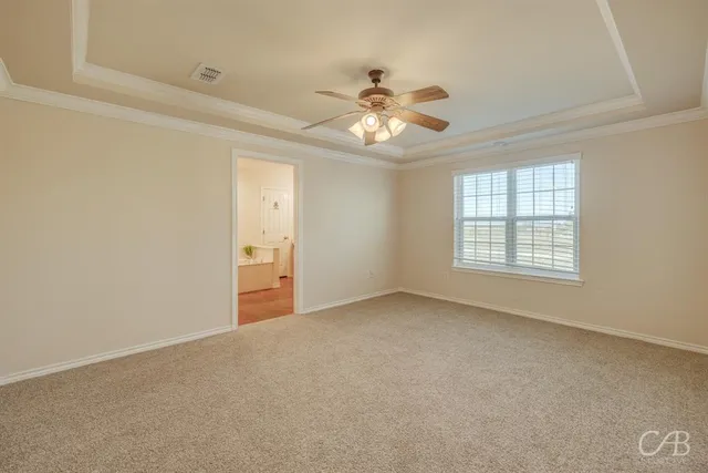 en empty room with a chandelier fan