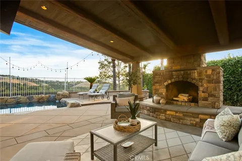 a living room with patio furniture and a floor to ceiling window