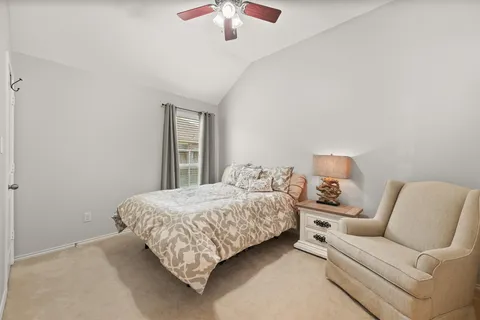 a bedroom with a bed couch and window