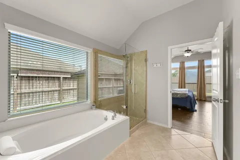 a bathroom with a bathtub and a shower