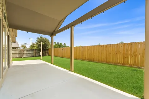 a view of a house with a floor to ceiling windows and a ceiling fan