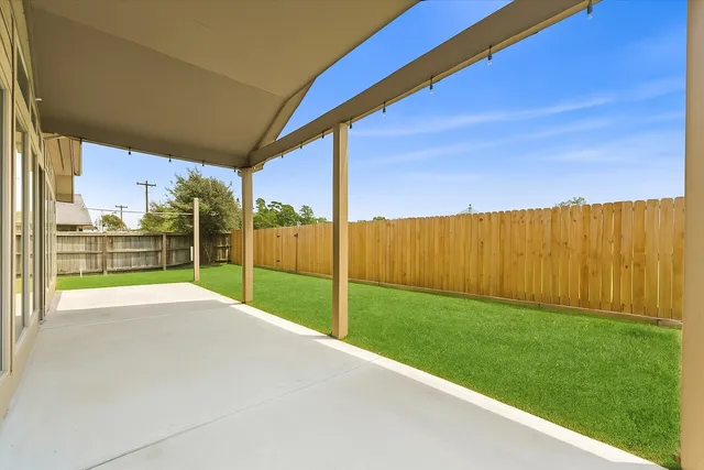 a view of a house with a floor to ceiling windows and a ceiling fan