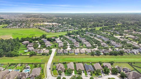 an aerial view of residential houses with outdoor space