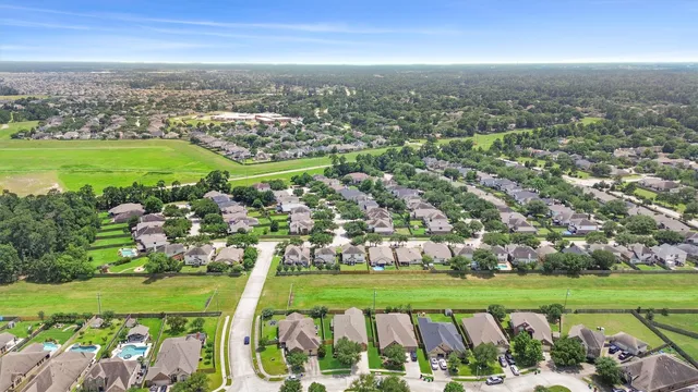 an aerial view of residential houses with outdoor space