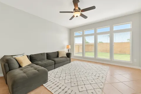 a living room with furniture and a large window