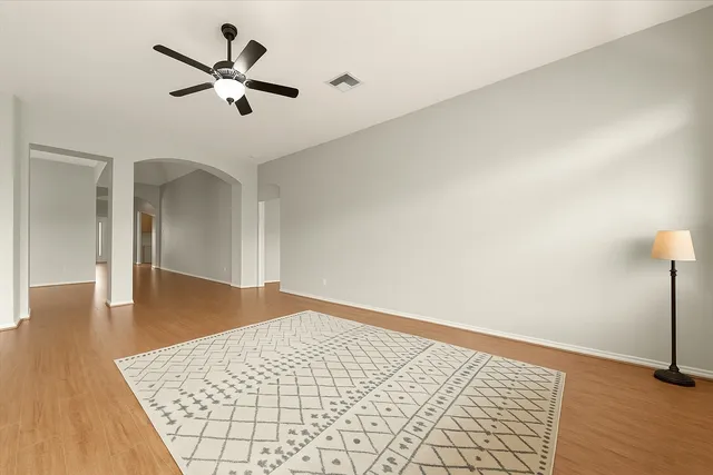 wooden floor in an empty room with a window