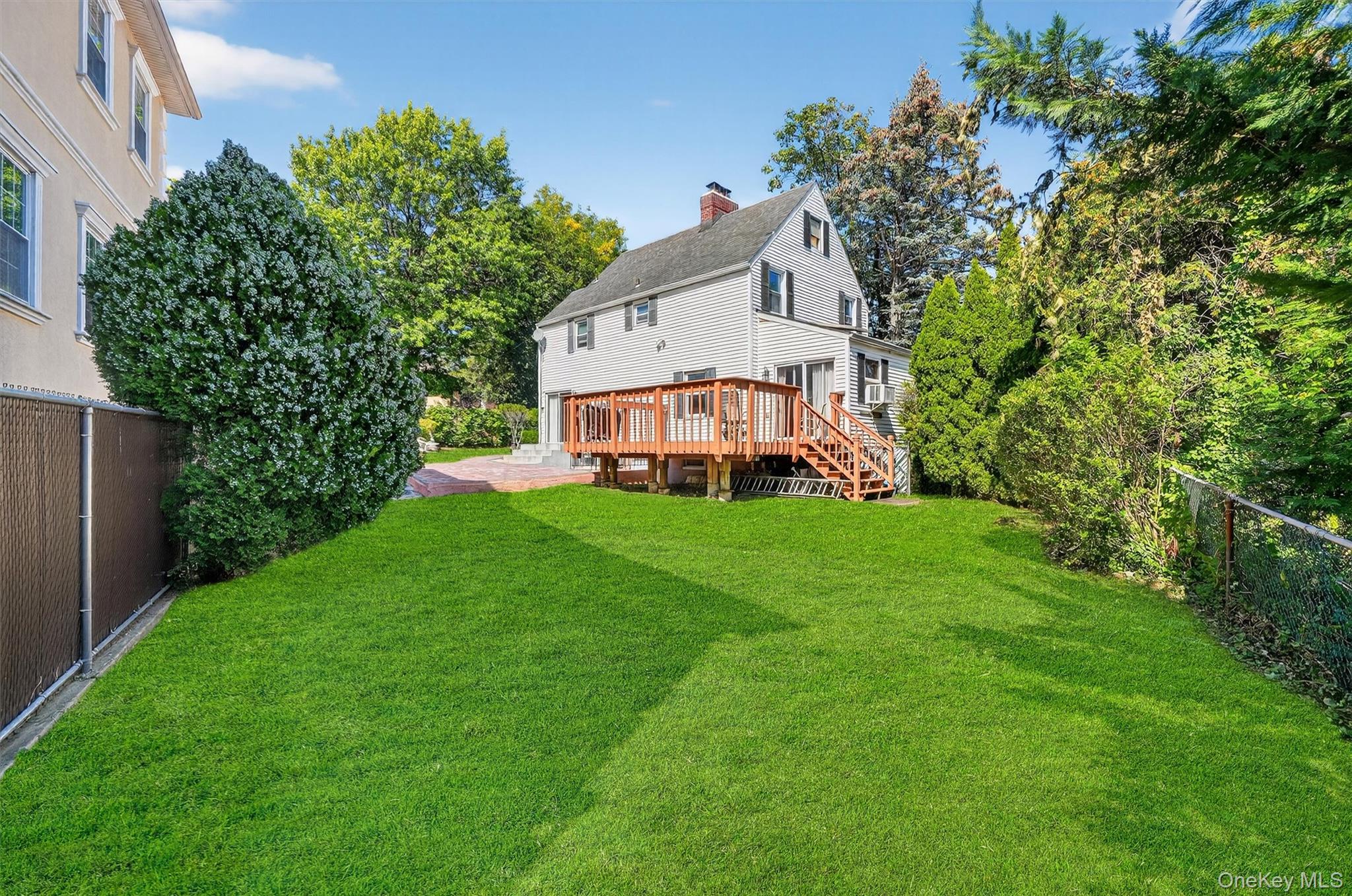 3384 Country Club Road Bronx, NY 10465 - Photo 41 of 48 Back of house featuring a fenced backyard, a chimney, a deck, and stairway