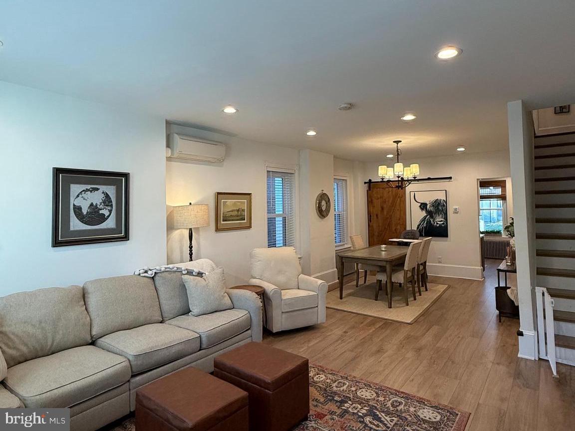 810 East Elm Street Conshohocken, PA 19428 - Photo 18 of 18 a living room with furniture a wooden floor and a flat screen tv