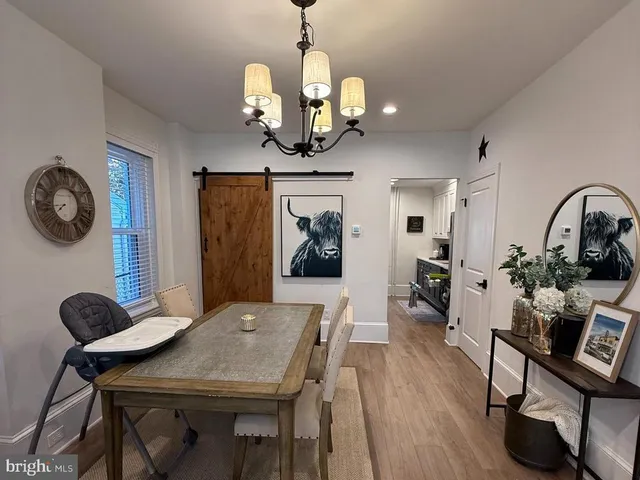 a living room with furniture a wooden floor and a flat screen tv