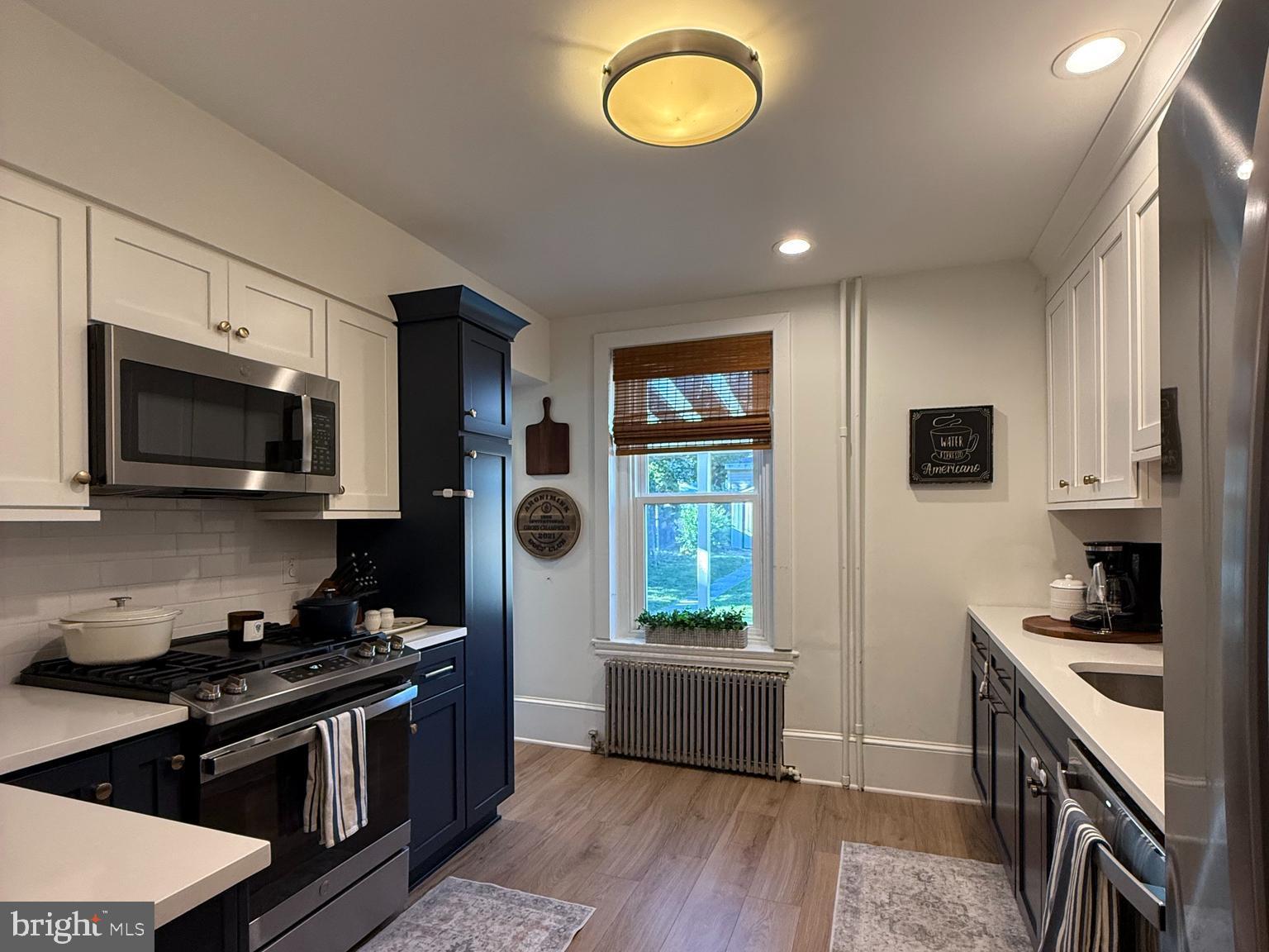 810 East Elm Street Conshohocken, PA 19428 - Photo 3 of 18 a kitchen with stainless steel appliances kitchen island granite countertop a stove a sink and a microwave