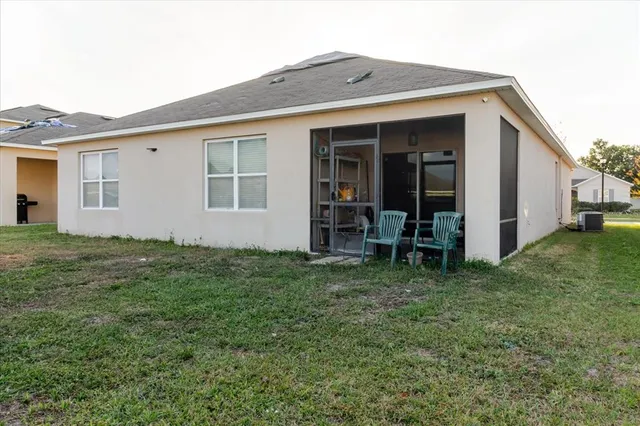 a view of a house with a backyard
