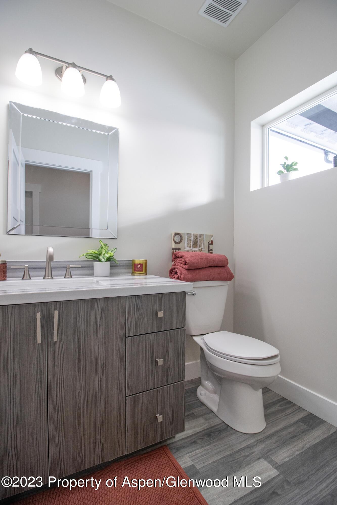 1089 Bedrock Circle Silt, CO 81652 - Photo 8 of 16 a bathroom with a sink vanity mirror and toilet