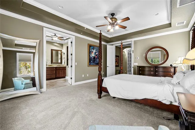 a bed room with a bed and ceiling fan