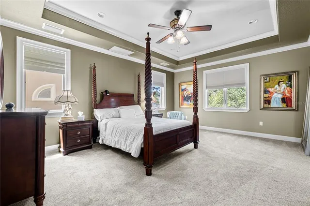 a bedroom with a bed and a chandelier