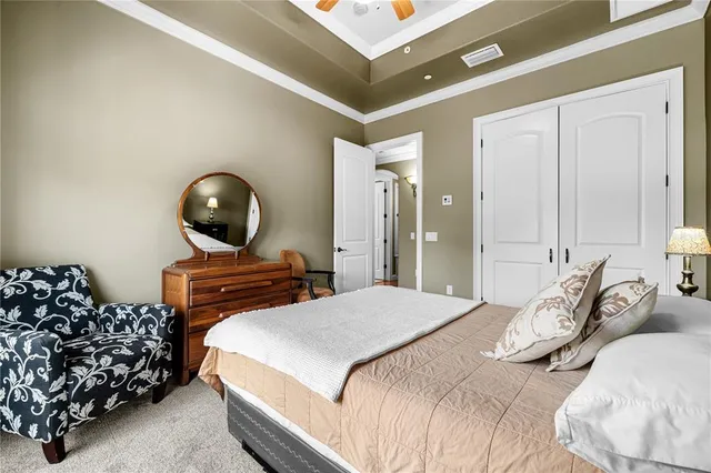 a bedroom with bed and a chandelier