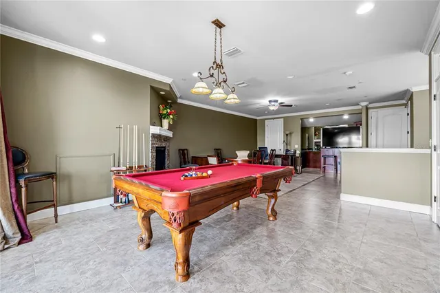 a room with pool table and windows