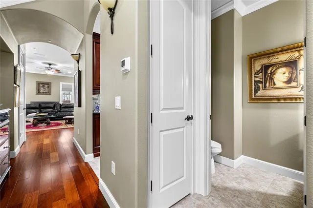 a view of a hallway view with wooden floor and living room