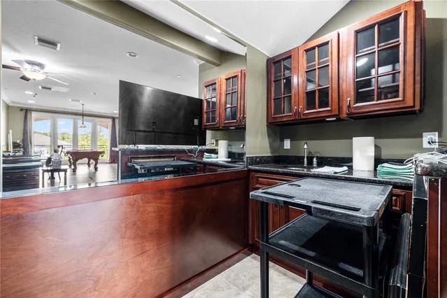 a kitchen with stainless steel appliances a stove a sink dishwasher and cabinets with wooden floor
