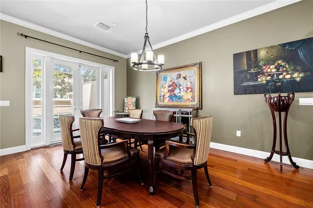 a view of a dining room with furniture wooden floor and chandelier