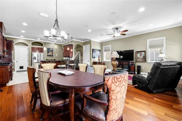 a view of a dining room with furniture a chandelier and wooden floor
