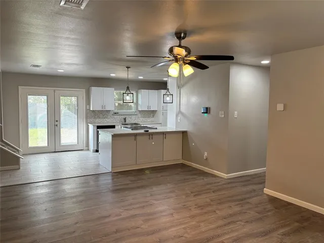 a view of a kitchen with a sink a refrigerator and a chandelier