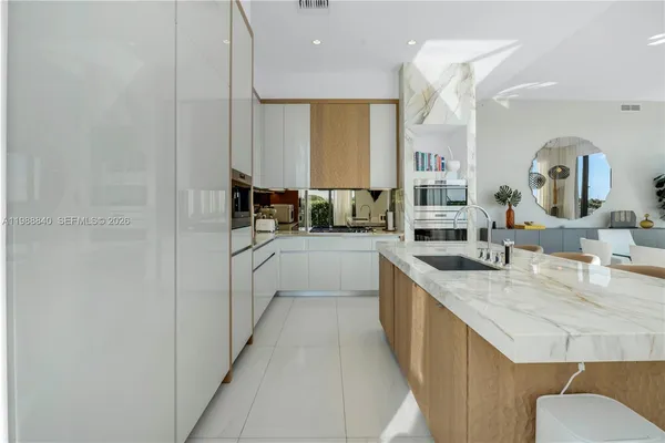 a large kitchen with a sink and cabinets