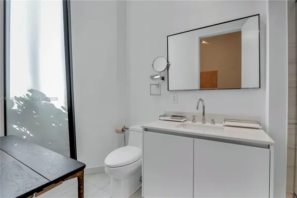 a bathroom with a toilet a sink and shower