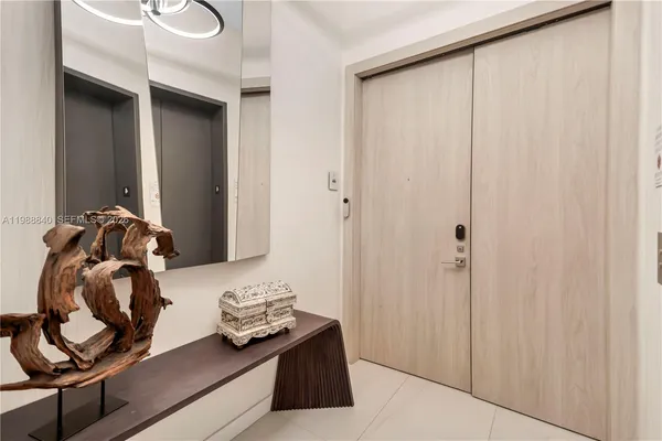 a living room with furniture and a floor to ceiling window