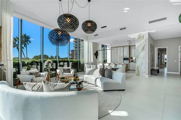 a view of a livingroom with furniture and a large window