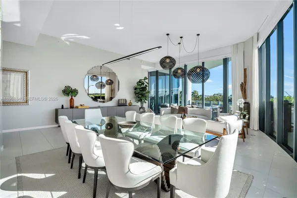 a dining room with furniture a large window and a clock