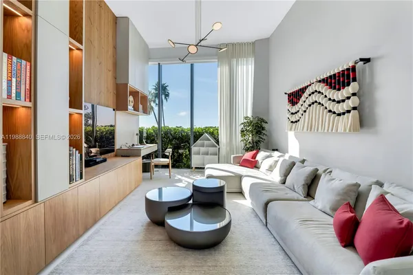 a living room with furniture and a large window