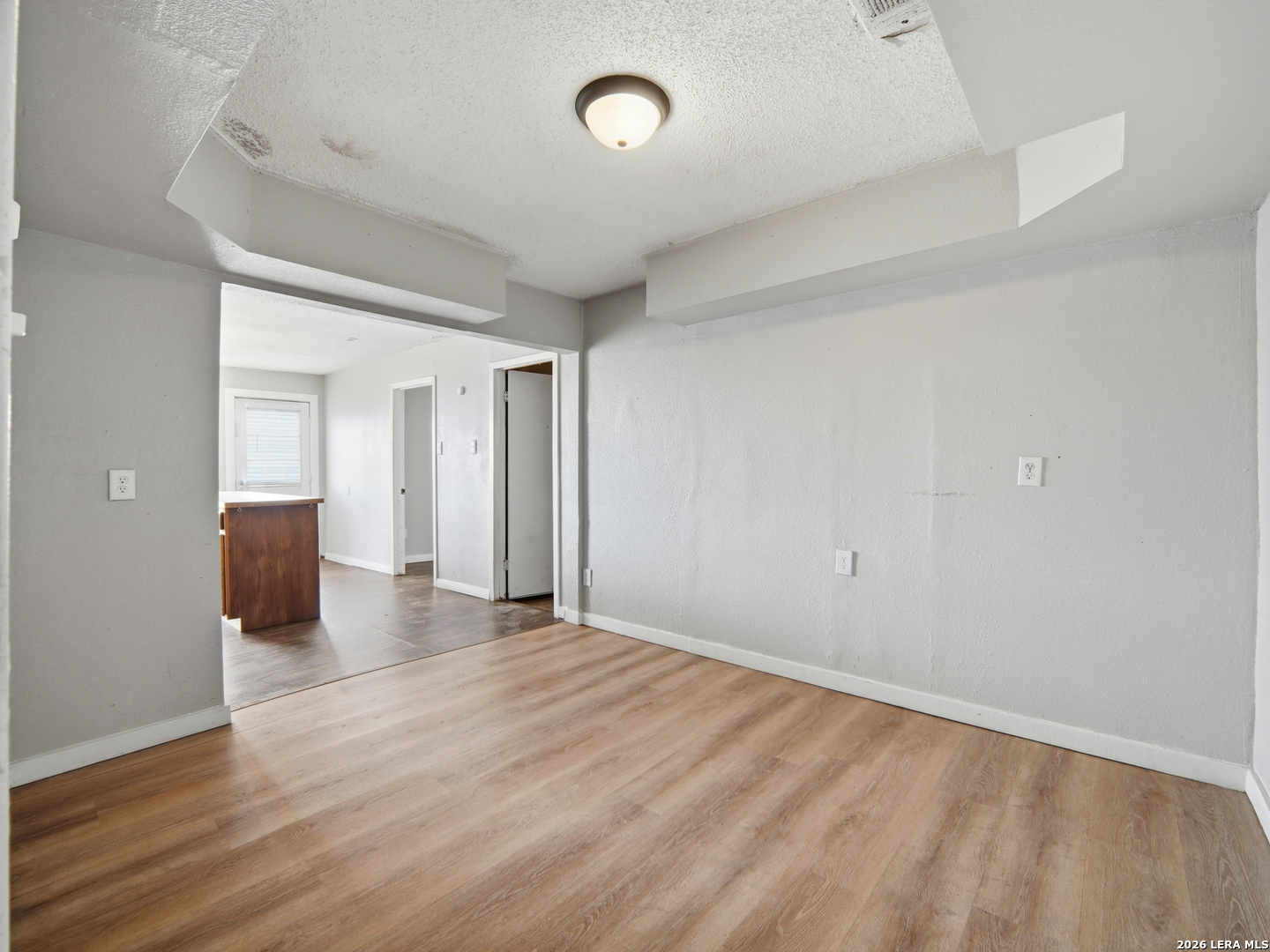305 Toepperwein Road Converse, TX 78109 - Photo 11 of 25 an empty room with wooden floor and windows