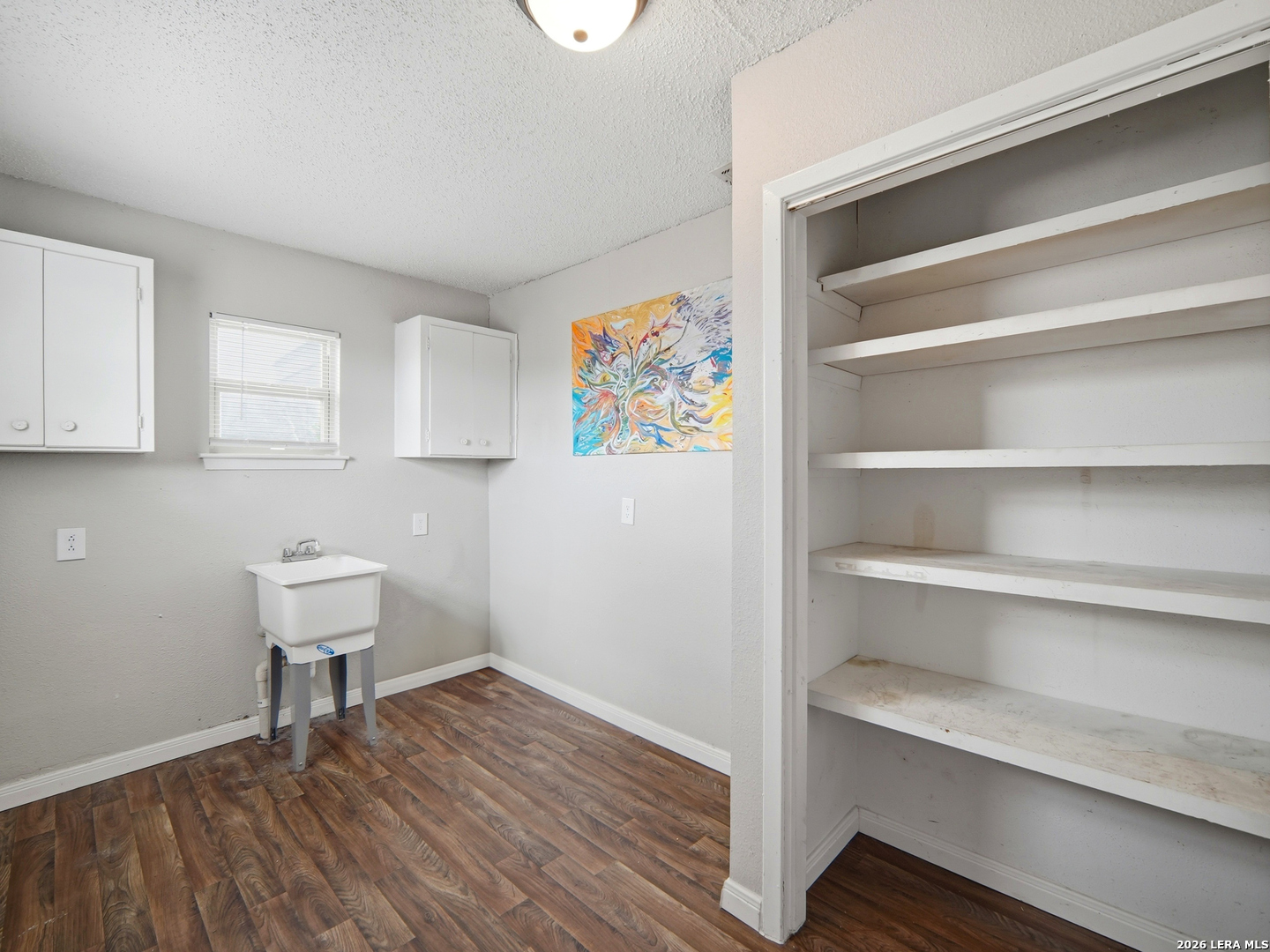 305 Toepperwein Road Converse, TX 78109 - Photo 13 of 25 a room with a bench and cabinets