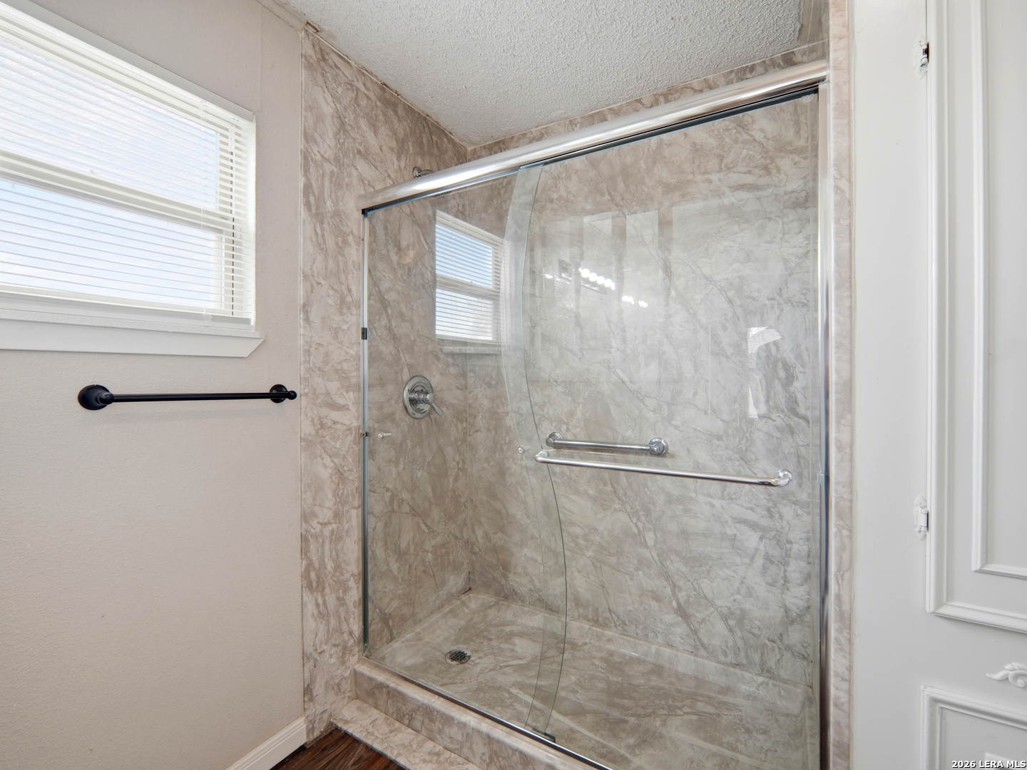 305 Toepperwein Road Converse, TX 78109 - Photo 14 of 25 a bathroom with a glass shower door