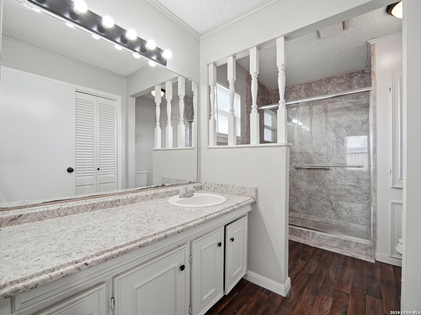 305 Toepperwein Road Converse, TX 78109 - Photo 15 of 25 a bathroom with a granite countertop sink a mirror and shower