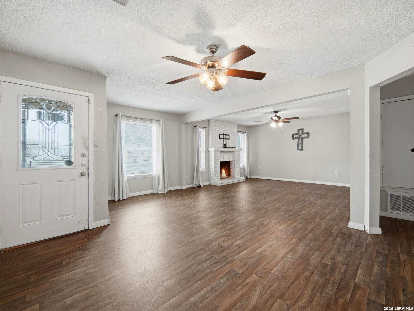 305 Toepperwein Road Converse, TX 78109 - Photo 5 of 25 a view of an empty room with wooden floor and a window