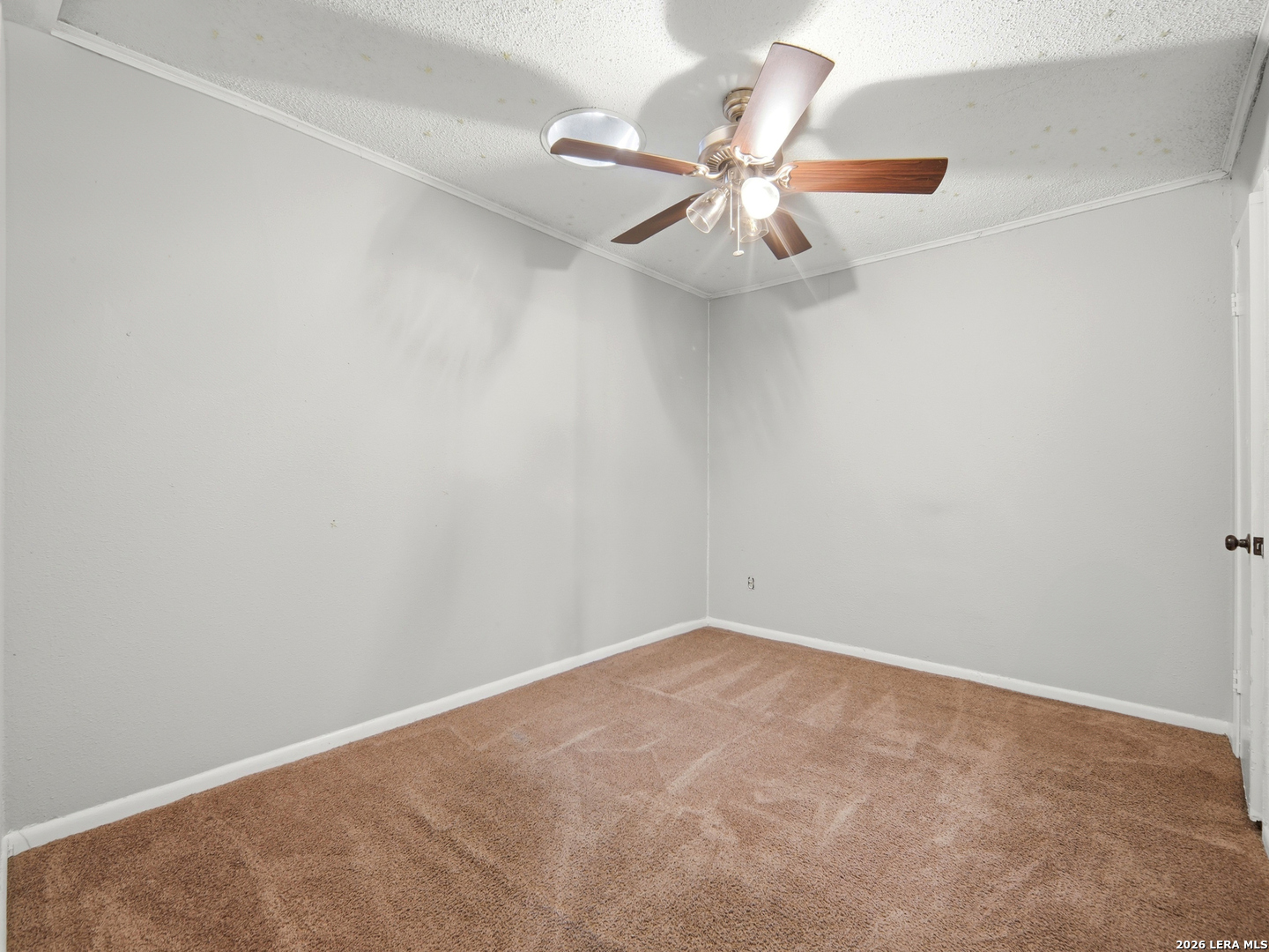 305 Toepperwein Road Converse, TX 78109 - Photo 7 of 25 an empty room with a chandelier fan and a view of a window