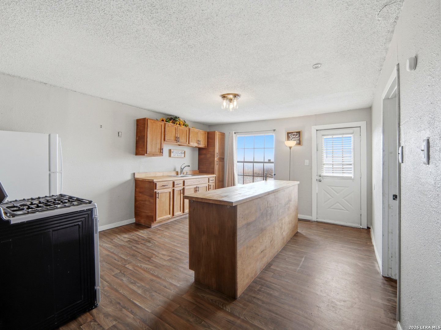 305 Toepperwein Road Converse, TX 78109 - Photo 10 of 25 a kitchen with stainless steel appliances a stove top oven and a refrigerator