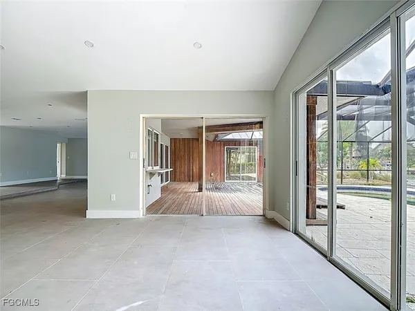 a view of an entryway with wooden floor and garden
