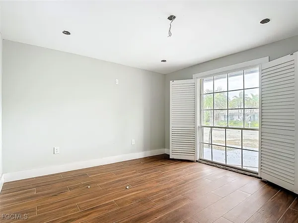 wooden floor in an empty room with a window