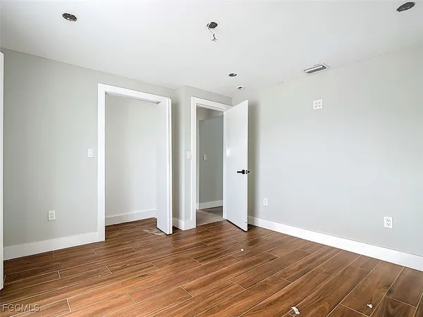 a view of an empty room with wooden floor